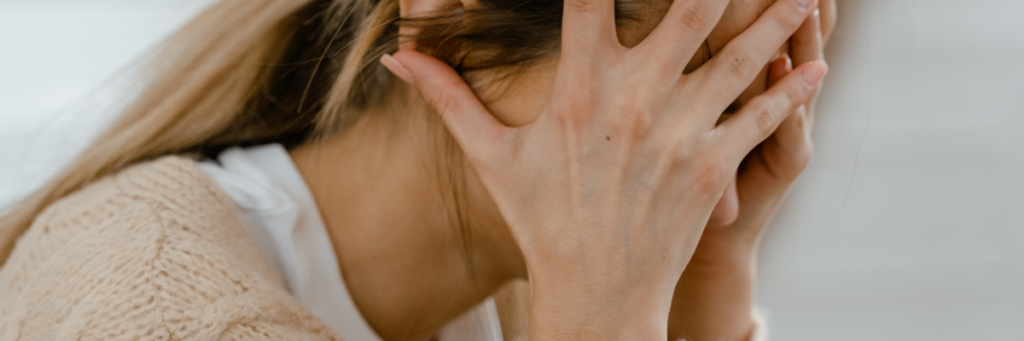 Woman hands over face