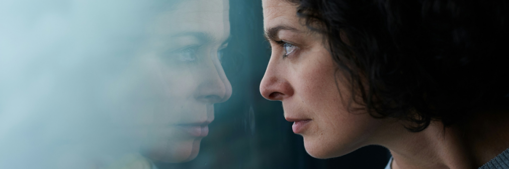 Woman thoughtful looking out of window