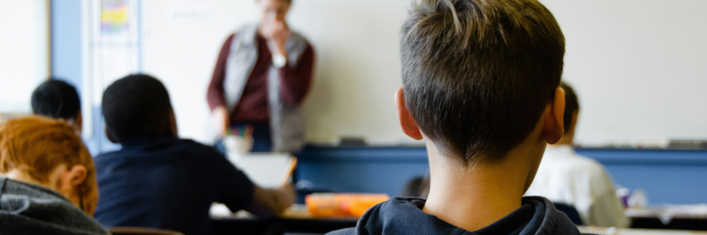 Tired child sat at desk in school